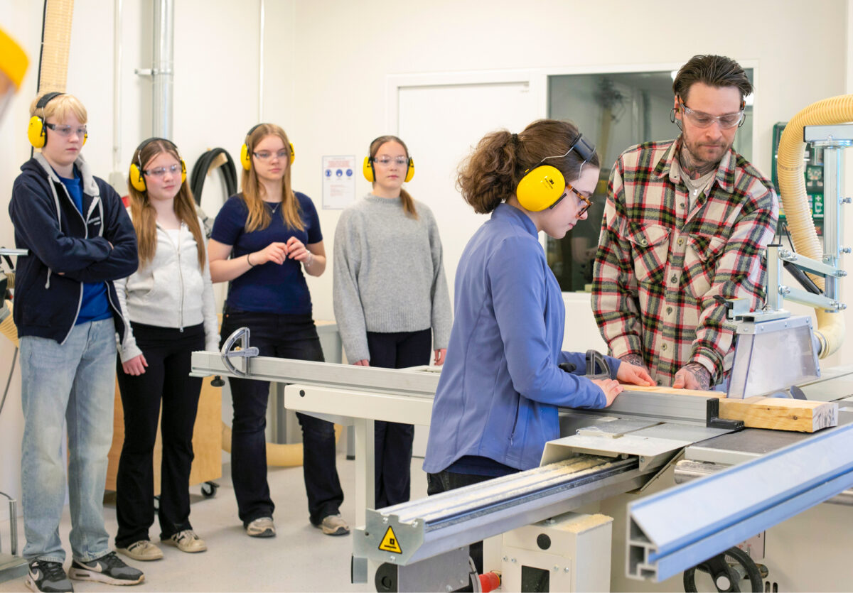 Rasmus (vas.), Alenia Lindholm, Elsa Kokko ja Alina Jaroma katsovat, kun Linn&eacute;a Lind&eacute;n ja opettaja Sebatian Lindstr&ouml;m ty&ouml;skentelev&auml;t p&ouml;yt&auml;sirkkelin &auml;&auml;ress&auml;.